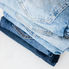 Pile of jeans in different tones of blue